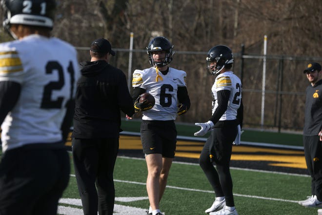 Iowa defensive back Zach Lutmer (6) hands off the ball during practice Thursday, April 11, 2024 in Iowa City, Iowa.