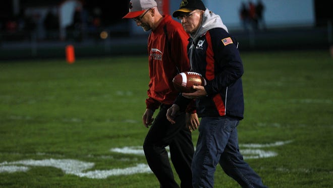 Dan Gable walks on field to present the game ball prior to the Little Hawks' game against Ames at City High on Friday, Sept. 12, 2014. David Scrivner / Iowa City Press-Citizen