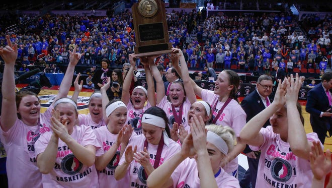 Members of the Crestwood girls basketball team hold the Class 3A state championship trophy after the Cadets beat Sioux Center on Saturday, March 3, 2018, during the Iowa high school girls basketball state championship game at Wells Fargo Arena in Des Moines.