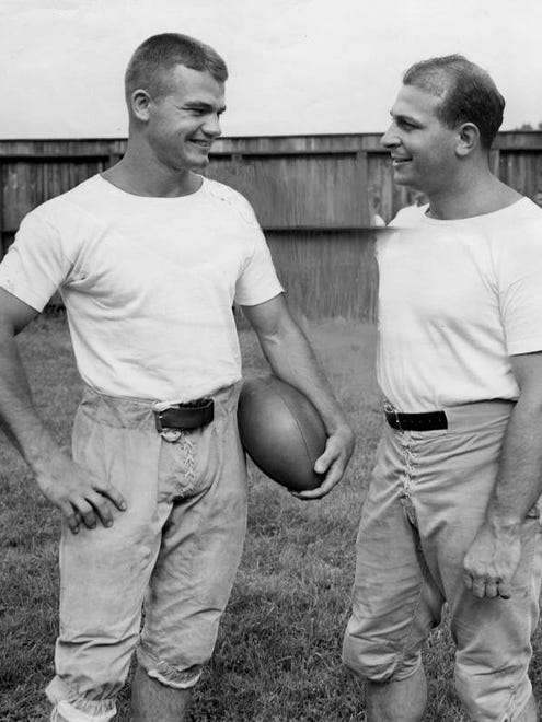 Aug. 12, 1940 - Nile Kinnick, left, talks to Frank Carideo, formerly of Notre Dame, at a college all-stars practice before a game with members of the Green Bay Packers.