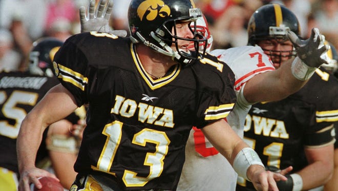 From 1998: Iowa QB Randy Reiners tries to elude grasp of a Wisconsin defender.