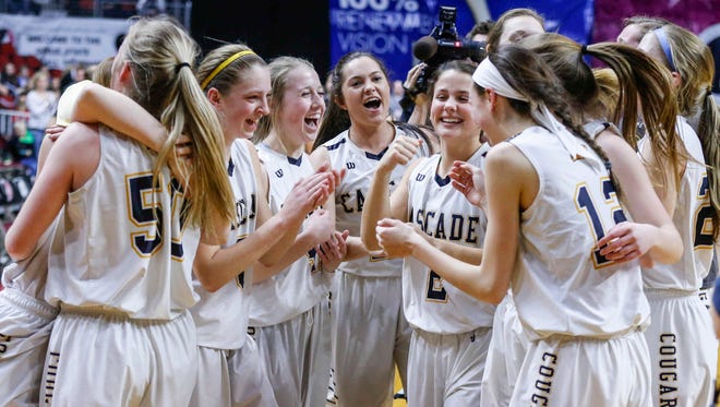 Members of the Cascade girls basketball team celebrate after a three-overtime win over North Union on Friday, March 2, 2018, at Wells Fargo Arena in Des Moines.