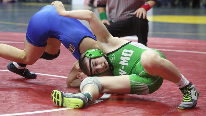 Southeast Warren/Melcher Dallas senior 132-pounder Blake Bauer (in green) wrestles Underwood sophomore Michael Baker in a Class 1A opening-round match at the state wrestling meet Feb. 16 at Wells Fargo Arena in Des Moines.