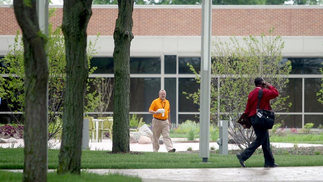 (Press-Citizen file photo) Employees walkabout the ACT grounds on Tuesday, May 28, 2013
