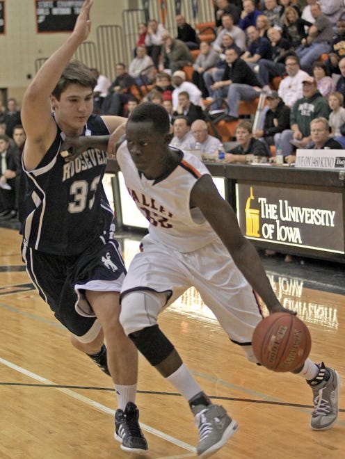 West Des Moines Valley's Peter Jok drives to the basket as Roosevelt's Chris Bennett, left, defends during a game at Valley on Dec. 2, 2011.