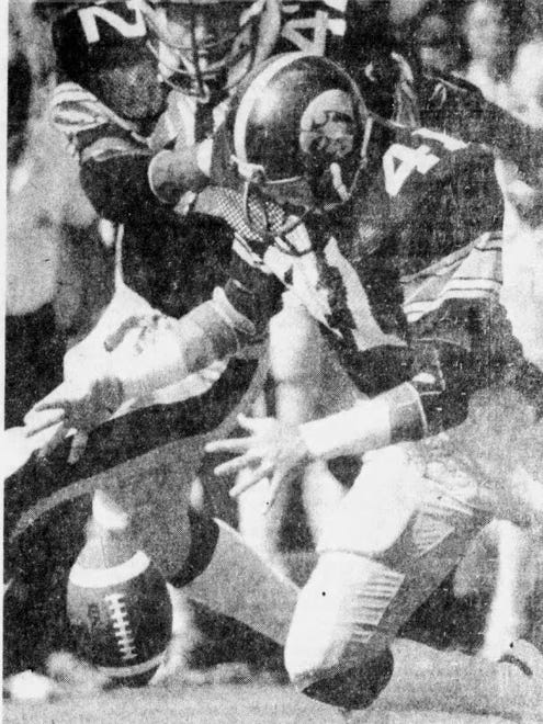 Iowa defensive back Bobby Stoops falls on a fumble during the 1979 Cy-Hawk football game in Iowa City. The Hawkeyes won, 30-14.