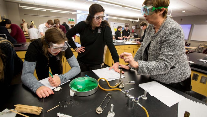 Clark, center, listens to Peg Conlon with her lab partners in advanced chemistry class Tuesday, Feb. 13, 2018. Caitlin Clark, a West Des Moines Dowling Catholic guard, is the nation's top-ranked sophomore, the subject of a recruiting battle between the country's top women's college programs and a member of the USA U16 national team.
