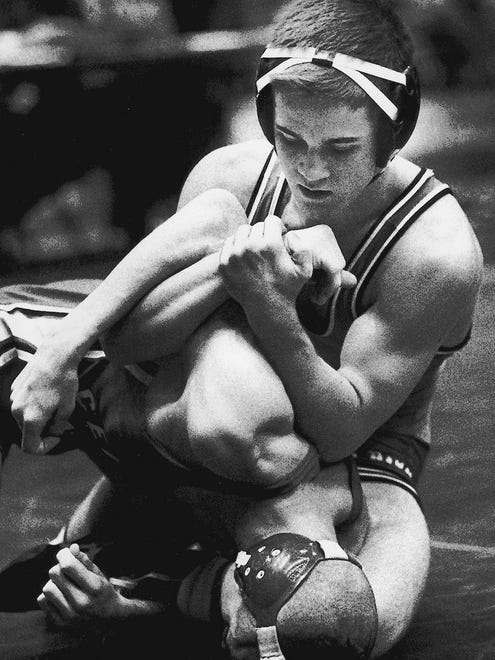 1992: Jeff McGinness of Iowa City High (top) becomes the ninth wrestler to win a fourth state crown in 1993. He is pictured in wrestling Joe Crum of Cedar Falls.