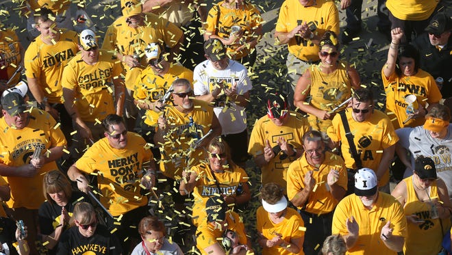 Iowa football fans throw confetti in the air before entering Kinnick Stadium to see the Hawkeyes battle Illinois State in the season opener on Saturday, Sept. 5, 2015, at Kinnick Stadium in Iowa City, Iowa.
