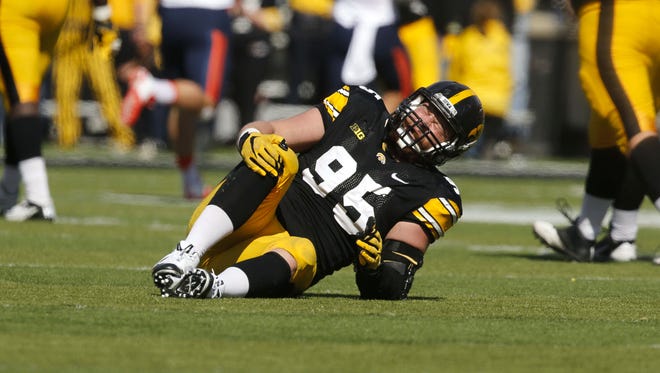 Iowa right end Drew Ott grabs his right knee after tearing his ACL against Illinois on Oct. 10.