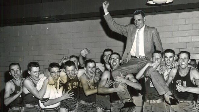 1959: Calumet coach Ray Knauer is lifted by his team after their Class B state boys' basketball championship.