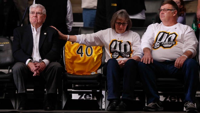 Former Iowa mens basketball head coach Tom Davis, left, is consoled by Patty Street, the mother of Chris Street, during a halftime ceremony against Purdue at Carver Hawkeye Arena in Iowa City on Saturday, January 20, 2018. This year marks the 25th anniversary of Street's death.