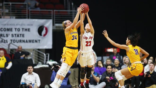 Johnston's Jennah Johnson and City High's Aubrey Joens reach for the ball during the Class 5A Girls' state basketball semifinal game between Johnston and Iowa City High on Thursday, March 1, 2018, in Wells Fargo Arena. City High won the game, 58-52, to advance to the state final.