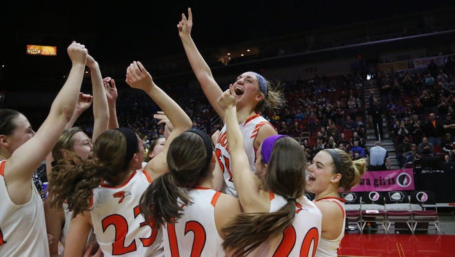 Springville players celebrate after winning the Class 1A Girls' state basketball quarterfinal game between Springville and Algona Bishop Garrigan on Wednesday, Feb. 28, 2018, in Wells Fargo Arena. Springville won the game 54-36.