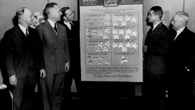 Nile Kinnick looks at the chart used to show the standing of candidates for the Heisman Trophy at the Downtown Athletic Club in New York City Dec. 6, 1939.