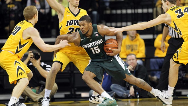 Michigan State's Marvin Clark, Jr. works around Iowa defenders during their game at Carver-Hawkeye Arena on Tuesday, Dec. 29, 2015.