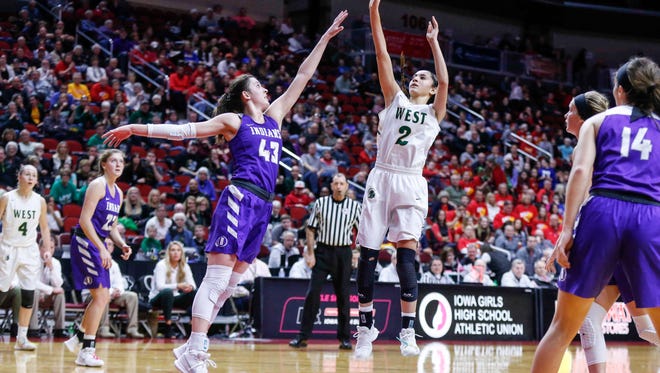 Iowa City West junior Cailyn Morgan launches a shot over the reach of Indianola senior Grace Berg during the 5A semifinal game at the girls state basketball tournament on Thursday, March 1, 2018, at Wells Fargo Arena in Des Moines.