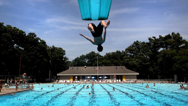17 year-old Sam Buatti takes a leap of faith from the high dive at City Park Pool on Wednesday, July 25, 2012. Patrons have been flocking in steady numbers to these blue oasis ' around the Iowa City area in an ettempt to beat the heat.
