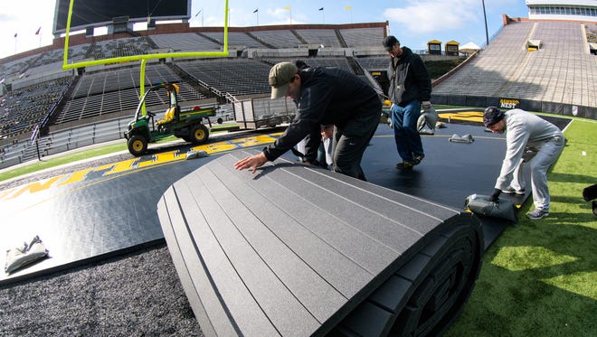 Iowa Athletics staff rolls out the mat as they set up for Saturday's Grapple on the Gridiron Thursday, November 12, 2015 at Kinnick Stadium. (Brian Ray/hawkeyesports.com)