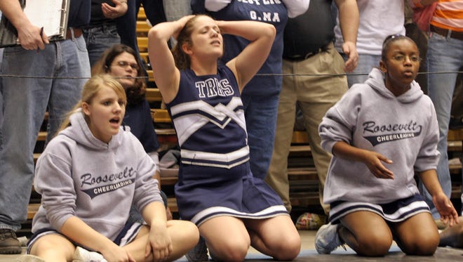 From 2005: Roosevelt High School cheerleader Clare Bridgeford, center, shows her frustration during during the opening round of state wrestling at Veterans Memorial Auditorium. Also pictured: Amanda Marek, left, and Demetria Witt, right.