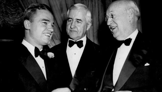 Nile Kinnick, left, talking with Jesse Jones, Federal Loans Administrator (center) and Senator Clyde L. Herring of Iowa, as they attend the annual dinner of the Touchdown Club in Washington, D.C. Kinnick was there to receive an award as the outstanding football player of 1939. Photo dated Jan. 17, 1940.