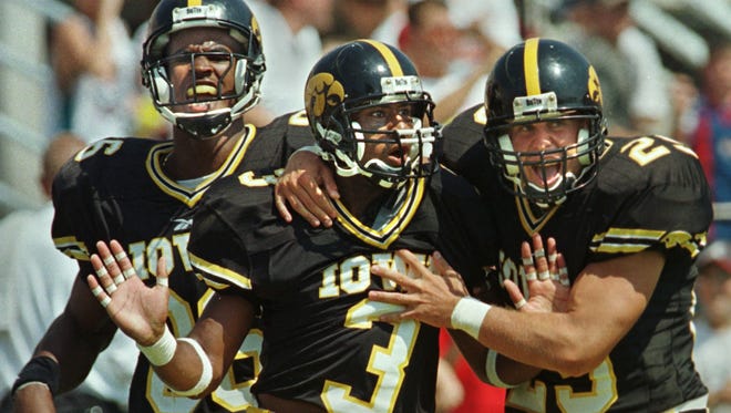 From 1998: Kahlil Hill is greeted by teammates Austin Wheatley, left and Jeff Buch after Hill returned a kickoff 88 yards for a touchdown against Central Michigan. Hill also had a 62-yard punt return for a touchdown in the victory.