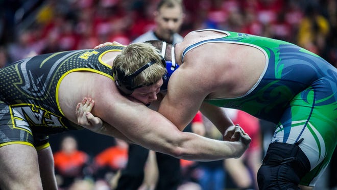 Belmond-Klemme's Cameron Beminio wrestles Louisa-Muscatine's Gabs Hayes during the first round of the Iowa high school state wrestling championship on Thursday, Feb. 15, 2018, in Wells Fargo Arena.