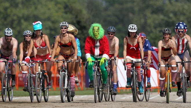 Cyclists make their way down the track during the Grinch's Single Speed Speedo Spectacular at the Johnson County Fairgrounds on Saturday, Sept. 24, 2016.