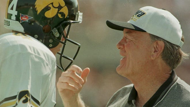 From 1998: Iowa coach Hayden Fry talks with freshman quarterback Kyle McCann during the Hawkeyes' 37-14 victory at Illinois. McCann had just connected on a 51-yard touchdown pass with receiver Kahlil Hill.
