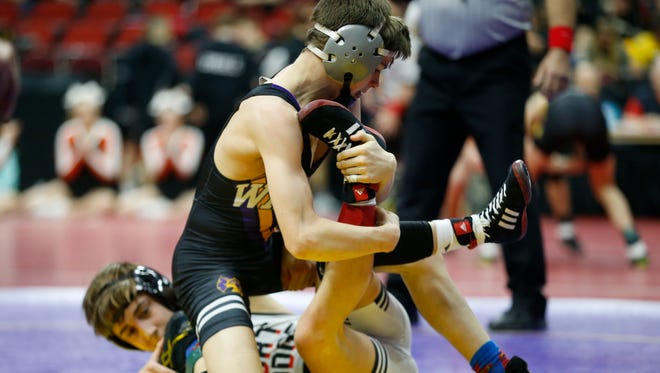 Waukee's Lucas Uliano grabs a hold of Fort Dodge's Drake Ayala Wednesday, Feb. 14, 2018, in their class 3A match at the 2018 Dual Team Wrestling championships in Des Moines.