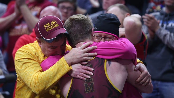 PCM's Lucas Roland hugs his mother, who is battling cancer, after winning his match during the championship round of the class 2A Iowa high school state wrestling tournament on Saturday, Feb. 17, 2018, in Wells Fargo Arena.