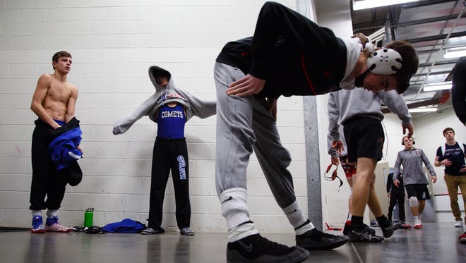 Wrestlers warm up before their first round 2A matches on Thursday, Feb. 15, 2018, in Des Moines.