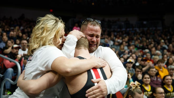 Fort DodgeÕs Brody Teske hugs his parents after beating Kaleb Olejniczak of Perry during their class 3A 126 pound championship match at Wells Fargo Arena on Saturday, Feb. 17, 2018, in Des Moines. This was Teske's his fourth state title.
