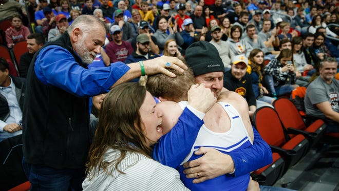 Zach Stewart of Perry celebrates a 3-1 victory over Deville Dentis of Des Moines East with his parents after his class 3A 138 pound championship match at Wells Fargo Arena on Saturday, Feb. 17, 2018, in Des Moines.