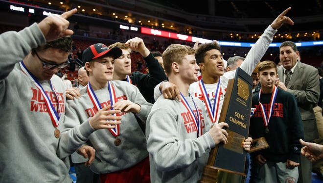 Fort Dodge celebrates its team victory during the state wrestling championships at Wells Fargo Arena on Saturday, Feb. 17, 2018, in Des Moines.