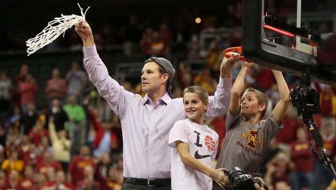 Iowa State head coach Fred Hoiberg cuts down the net with his sons after the Big 12 Championship title game between Iowa State and Kansas on  March 14, 2015, in Kansas City, Mo.