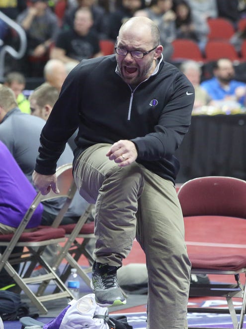 Indianola assistant coach Jeremy Whalen urges on Indianola senior 285-pounder Eagan Lickiss as he wrestles Waterloo East senior Omar Begic in a Class 3A opening-round match at the state wrestling meet Feb. 16 at Wells Fargo Arena in Des Moines.