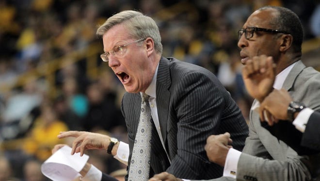 Iowa head coach Fran McCaffery calls for a traveling call during the Hawkeyes' game against South Dakota at Carver-Hawkeye Arena on Tuesday, Dec. 4, 2012.