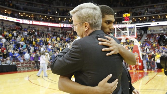 Iowa Hawkeyes head coach Fran McCaffery  hugs Iowa Hawkeyes guard Devyn Marble (4) at mid court after defeating the Northern Iowa Panthers 80-73 in the Big 4 Classic NCAA Mens Basketball tourney at the Wells Fargo Arena in Des Moines.