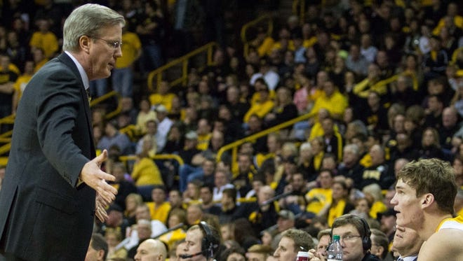 Iowa's head coach Fran McCaffery talks to Adam Woodbury (34) after he earned his fourth foul in the second half of play at Carver-Hawkeye Arena, Saturday February 9, 2013. The Hawkeyes defeated the Wildcats 71-57 to improve to 15-9 overall and 4-7 in the Big Ten.