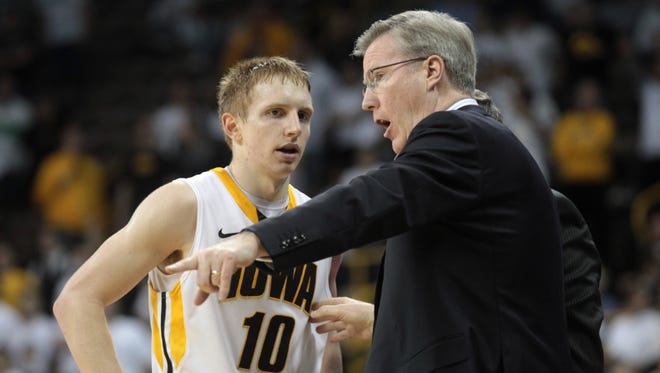Iowa head coach Fran McCaffery talks to Mike Gesell during the Hawkeyes' game against Michigan State at Carver-Hawkeye Arena on Thursday, Jan. 10, 2012.
