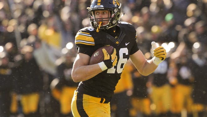Iowa's George Kittle glances back as he runs in for a 35-yard touchdown during the Hawkeyes' game against Purdue at Kinnick Stadium on Saturday, Nov. 21, 2015.