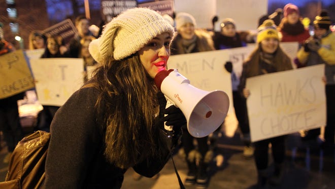 University of Iowa freshman Alexandria Yakes leads a group of protestors prior to the arrival on Republican presidential candidate Donald Trump at the University of Iowa Field House in Iowa City on Tuesday, Jan. 26, 2016.