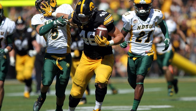 Iowa tight end George Kittle stiff-arms North Dakota State's Robbie Grimsley to complete a 37-yard play during their game at Kinnick Stadium on Saturday, Sept. 17, 2016.