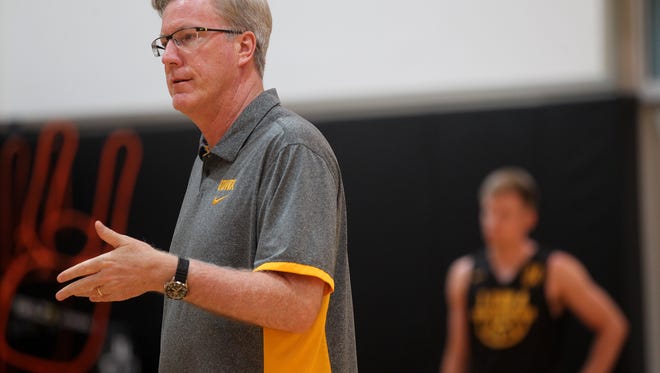 Iowa head coach Fran McCaffery works with players during practice at Carver-Hawkeye Arena on Wednesday, Aug. 2, 2017.