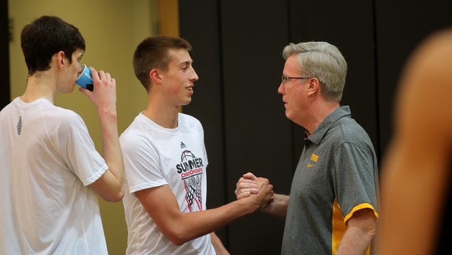 Iowa head coach Fran McCaffery greets Joe Wieskamp and his son, Patrick (left), during practice at Carver-Hawkeye Arena on Wednesday, Aug. 2, 2017.