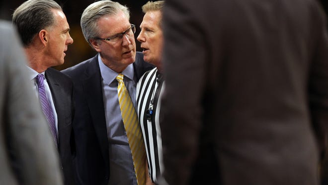 Iowa head coach Fran McCaffery and TCU head coach Jamie Dixon get word of a double technical foul on their players during their NIT second round game at Carver-Hawkeye Arena on Sunday, March 19, 2017.
