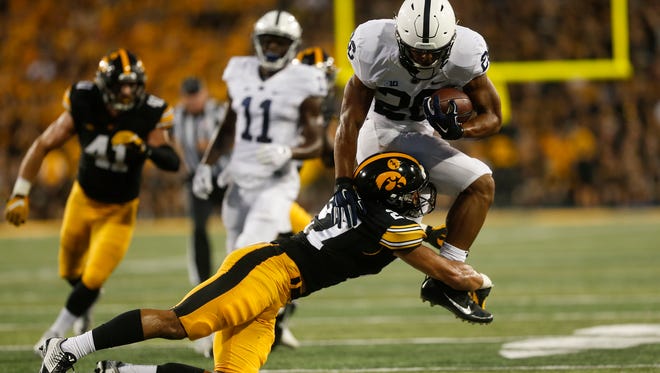 Iowa's Amani Hooker tackles Penn State's Saquon Barkley during their game at Kinnick Stadium on Saturday, Sept. 23, 2017.