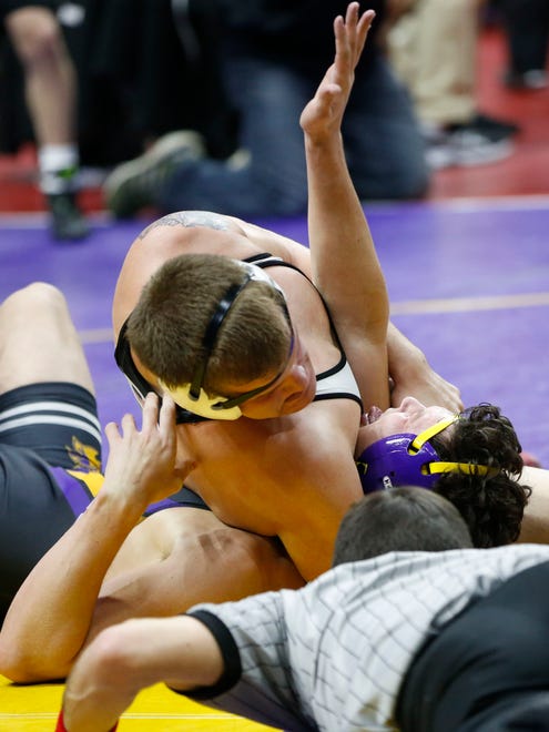 Waukee's Jake Morrison reaches up as Fort Dodge's Tim Elliott gets the pin Wednesday, Feb. 14, 2018, in their class 3A match at the 2018 Dual Team Wrestling championships in Des Moines.