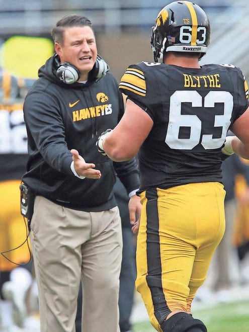 Iowa's Austin Blythe gets a high-five from offensive line coach Brian Ferentz during their game against Maryland Saturday, Oct. 31.